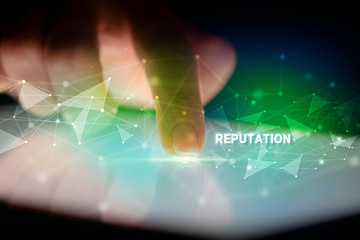 Finger touching tablet with REPUTATION inscription, business concept