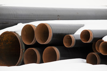 Construction Materials. Plastic industrial pipes under snow.