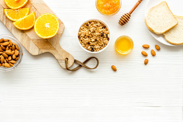 Vegetarian breakfast with granola and fruits on white background top-down frame copy space
