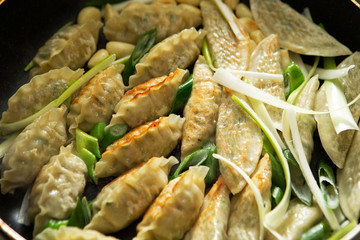 Pan fried dumpling with scallion and garlic