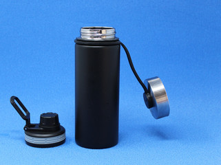 steel water bottle and silicone straws on a blue background