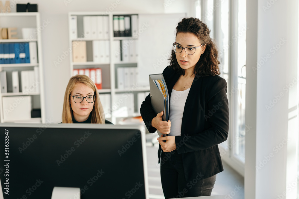 Wall mural two troubled young businesswoman in the office