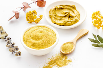 Yellow cosmetic clay - skin cleansing concept - on white background