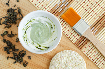 Fresh yogurt with matcha powder in the small white bowl. Diy natural beauty treatment and spa...
