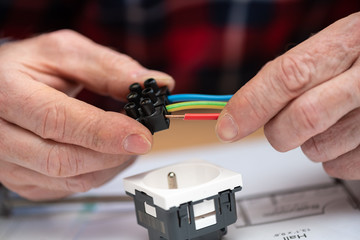 Electrician connecting wires in terminal block