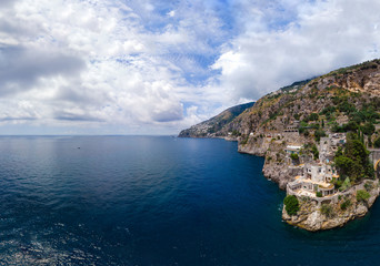 Fototapeta na wymiar Aerial view of the rocky seashore of southern Italy. Incredible beauty panorama of mountains and sea. Travel and tourism. Sunny summer day. Fiordo di furore beach. Praiano, Amalfi coast.