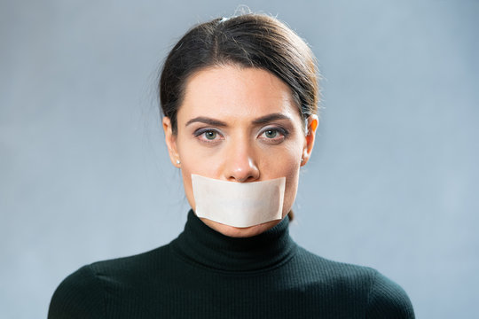 portrait of a girl in black with a closed mouth, closeup. censorship concept