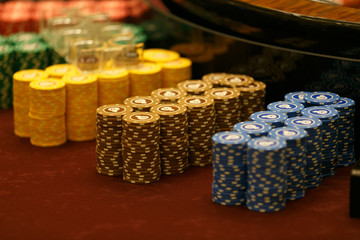 Gaming chips are on the card table. Smooth rows of playing chips in a casino.