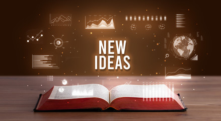 NEW IDEAS inscription coming out from an open book, creative business concept