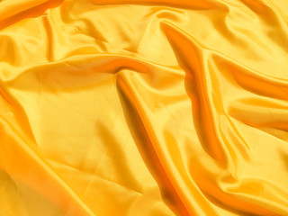 Beautiful yellow silk or satin texture background with copy space for design and artwork