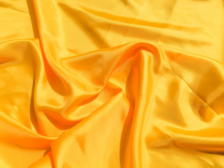 Beautiful yellow silk or satin texture background with copy space for design and artwork