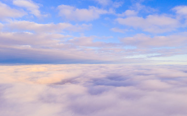 Fototapeta na wymiar Aerial view White clouds in blue sky. View from drone. Aerial top view cloudscape. Texture of clouds. View from above. Sunrise or sunset over clouds. Panorama clouds