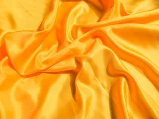 Yellow silk or satin texture background with copy space for design