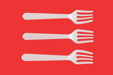 three plastic white forks on a red background. isolate. Top view.
