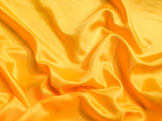 Yellow silk or satin texture background with copy space for design