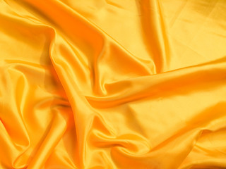 Yellow silk or satin texture background with copy space for design