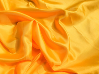 Yellow silk or satin texture background with copy space for design