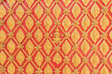 Golden small Buddha image on the wall of the temple