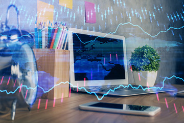 Financial graph colorful drawing and table with computer on background. Double exposure. Concept of international markets.