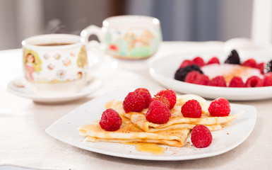 delicious  pancakes with fresh raspberries and honey