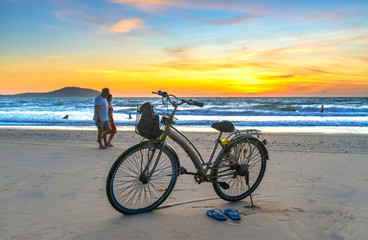 Fototapeta premium A bike by the beautiful beach at dawn, this is a means for a coastal walk of fishermen