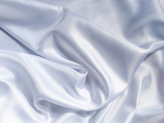 Obraz premium white crumpled fabric texture background. Silk curtain with fold waves for design