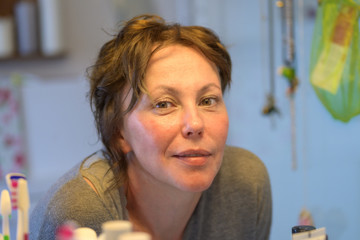 Smiling woman looking in a mirror