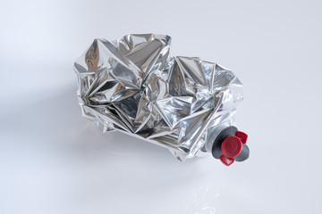 Crumpled plastic wine bag on white background