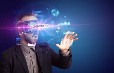 Businessman looking through Virtual Reality glasses with ACHIEVEMENT inscription, new business concept