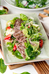 Salad of meat, tomato, cucumbers and fresh herbs
