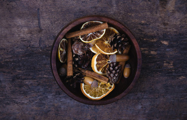 Tangerines, cones, spices on a wooden background. Сoncept of New Year and Christmas, Christmas drink Mulled wine. Flat lay, top view. Banner