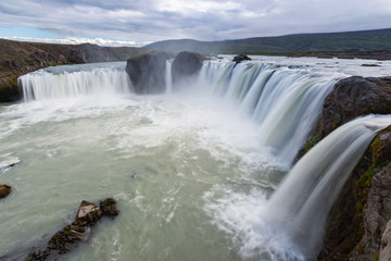 Beautiful Icelandic waterfall at sunset with huge quantity of flowing waters Iceland