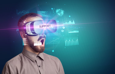 Businessman looking through Virtual Reality glasses with SUPPORT inscription, new business concept