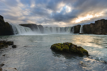 Beautiful Icelandic waterfall at sunset with huge quantity of flowing waters Iceland