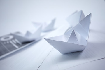 Naklejka premium business concept - paper boats on the documents