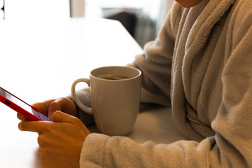 girl with an infusion and the phone on the table