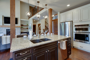 White and brown cabinets luxury huge kitchen interior with amazing details and top noch appliances.