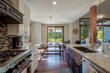 White and brown cabinets luxury huge kitchen interior with amazing details and top noch appliances.