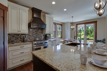 White and brown cabinets luxury huge kitchen interior with amazing details and top noch appliances.