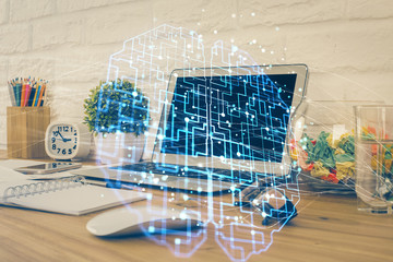 Double exposure of work space with computer and human brain drawing hologram. Brainstorm concept.