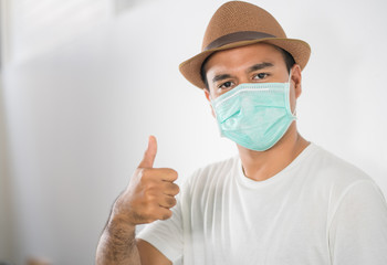 The young man had a cold and a fever. He wearing  protection mask. coronavirus or covid 19 concept.