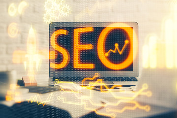 Double exposure of table with computer and seo drawing hologram. Search optimization concept.