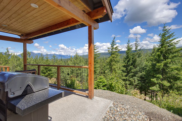 Amazing balcony patio with fire pit and forest and mountains view. Dream come true home exterior....