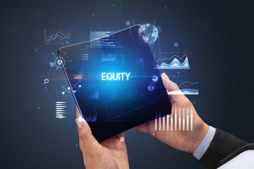 Businessman holding a foldable smartphone with EQUITY inscription, successful business concept
