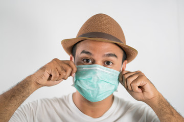 The young man had a cold and a fever. He wearing  protection mask. coronavirus or covid 19 concept.