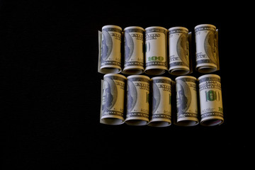  Banknotes on a black background, isolated in black. Money is twisted. Beautiful abstraction on the theme of finance.