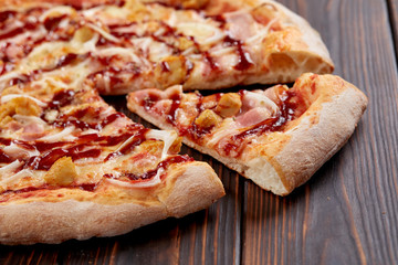 tasty pizza on the wooden background