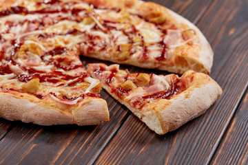tasty pizza on the wooden background