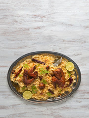 Homemade chicken Biryani. Arabic traditional food bowls Kabsa with meat.