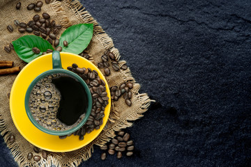 still life photography of black coffee in coffee cup set on the old black stone kitchen table on top view